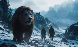 two men in winter gear walk beside a large brown bear