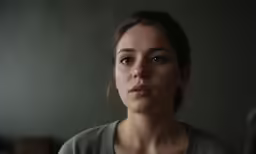 a woman is staring at the camera with only one eye