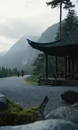 an empty road near some tall mountains in a forest