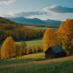 an old barn stands in a field with trees with fall foliage