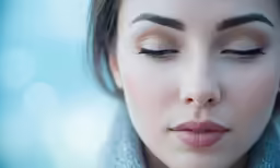 a woman with her eyes closed and she has her eyeliner painted red