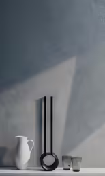 two pots and a vase sit on a shelf
