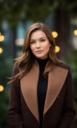 a woman is wearing a coat and standing outside