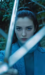 a woman holding a sword and posing for a photo