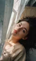 a women who has fallen asleep with her head turned to look away