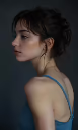 a woman in a blue dress poses for a portrait