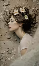 a woman laying down on the ground with a flower in her hair