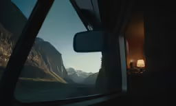 the view of mountains and a valley taken from a car window
