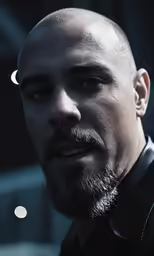 a man with a bald head looks off into the distance
