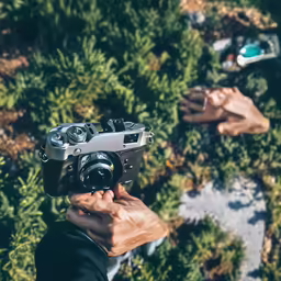 there is a person holding up a camera in the foreground