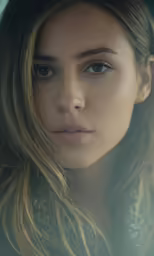 a very pretty woman with blue eyes posing for a photo