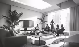 black and white photo of living room with friends