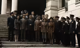 many people are posing for the camera with many men and women