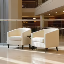 a view of an atrium, with two white chairs and a table on the floor