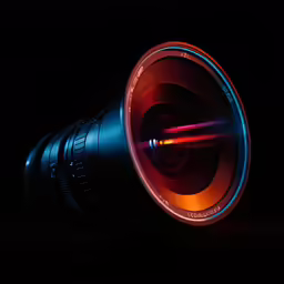 camera lens with flash light glowing on the dark background
