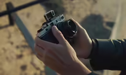 someone holding an open camera in their hands