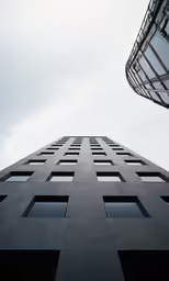 the side of a high building with windows on each side