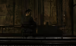 a woman sitting on a chair in a dimly lit room