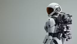 a robot standing against a gray background