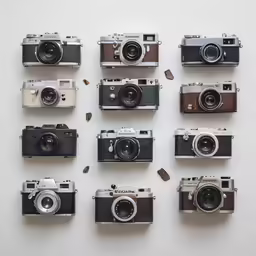 a group of four old cameras sitting side by side