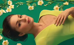 a woman laying down with flower decorations around her