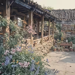 the house has flowers on the sidewalk in front of it