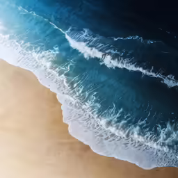 the ocean waves on the sandy beach