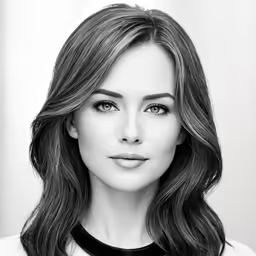 a young woman posing for a photo wearing black and white