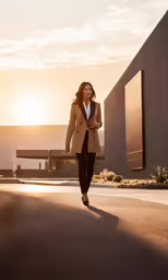 a young woman in business clothes is walking on the street