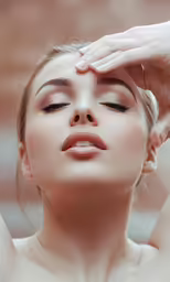a woman having a touchup on her face