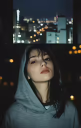 a woman in a hoodie stares off into the distance while standing next to a window