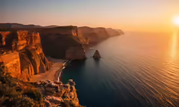 the sun is setting at the top of the cliffs by the ocean