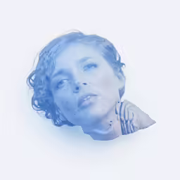 woman with blue hair posing in front of a white backdrop