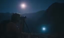 person holding a camera up to the sun