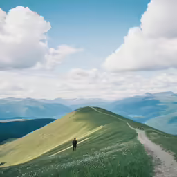 two people on a mountain top are holding hands