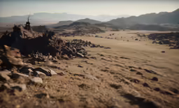 desert with mountains in the distance with rocks in the foreground
