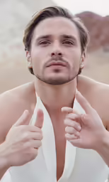 a shirtless man with the hands up