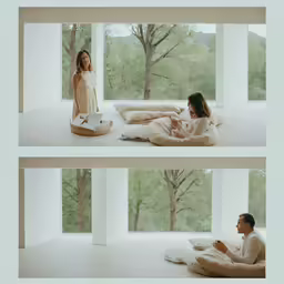 a couple of people sitting on top of a bed
