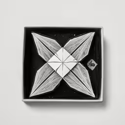 a paper craft of two birds on a black tray