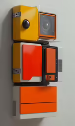 a small group of different colored boxes attached to a wall