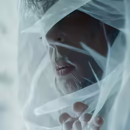 an extremely young woman wrapped in sheer veils