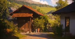 a small house that has been built into the side of a mountain,a dirt road passing by some small buildings