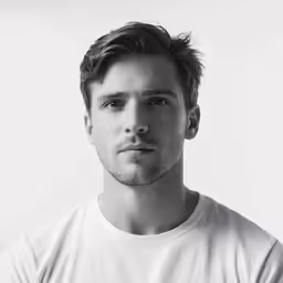 a man standing in a t - shirt in black and white