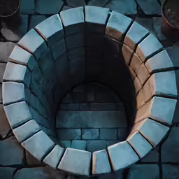 a brick ring is on the ground surrounded by a planter
