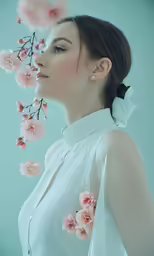 a woman is shown in profile and flowers in her hair