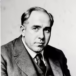 a man in a suit with his hand on his chest