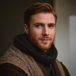 a man wearing a scarf and brown jacket