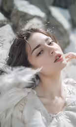 young beautiful woman in white dress posing in natural winter setting