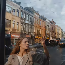 a woman taking her picture with the phone at a bus stop