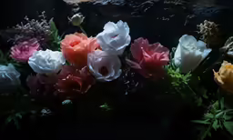 multicolored flowers are growing on the table